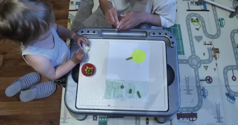 Exploring Creativity Mother Teaching Baby to Mold Clay in a Playful Scene Stock Footage 242806165
