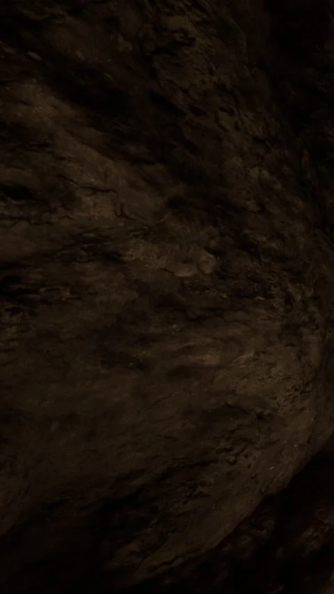 Exploring the dark and rough textures of a cave wall in the underground Stock Footage 341243584