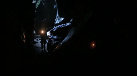 Exploring dark cave with flashlight Stock Footage 39687171