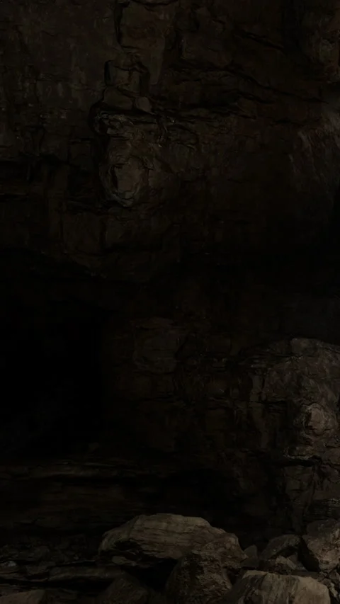 Exploring a dark cave with rocky walls and hidden corners Stock Footage 331752320