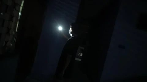 Exploring Darkness with a Flashlight Stock Footage 313467771