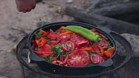 Exploring the Delight of Fresh Vegetable Cooking Over a Campfire in Natures Stock Footage 314974736