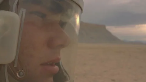 Exploring the desert in an astronaut helmet during sunset Stock Footage 288823647