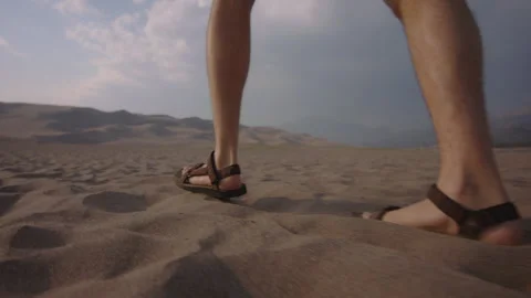 Exploring the desert terrain with comfortable walking sandals for sandy Stock Footage 288564377