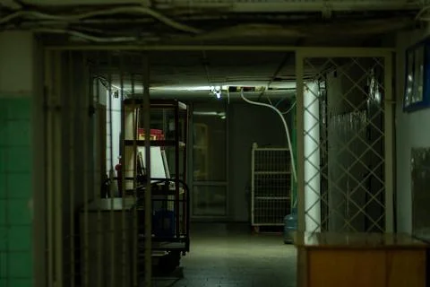 Exploring a Dimly Lit Basement Corridor with Shelves and a Work Table in an.. Stock Photos