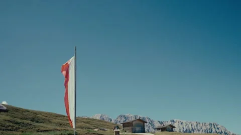 Exploring the Dolomites in a Sunny Mountain Landscape with a Waving Flag 库存影片 331166174