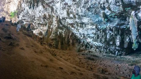 Exploring a dramatic limestone cave interior Stock Photos