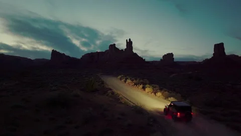 Exploring the dramatic terrain of Utah Valley of Gods Desert Road at dusk Stock Footage 288873971