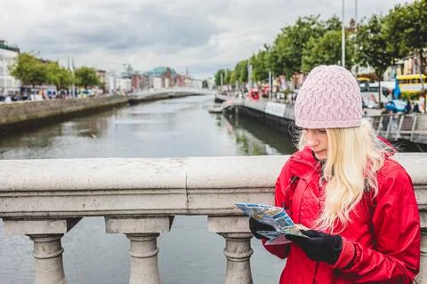 Exploring dublin's riverfront with a map on a cool autumn day 스톡 사진