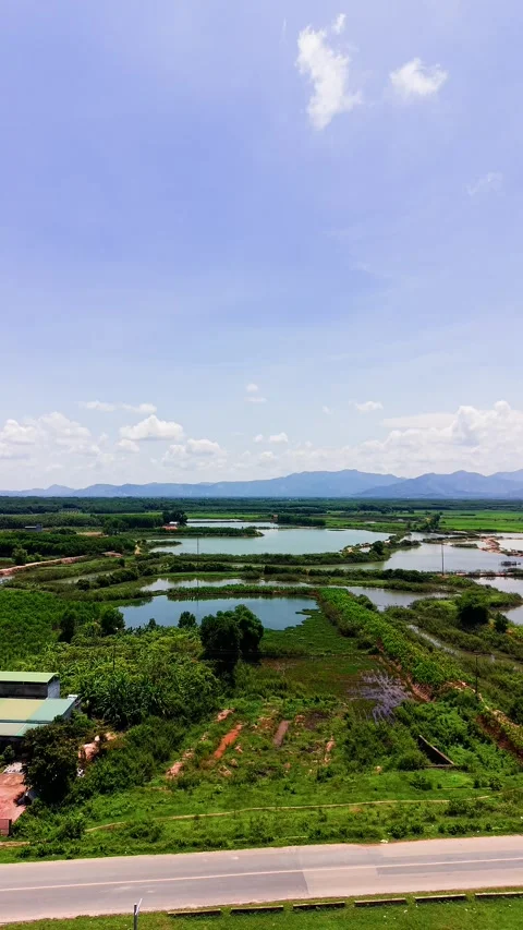 Exploring Duc Linh Lam Dong Vietnam with aerial views of fields and water Stock Footage 342705990