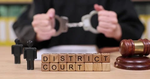 Exploring the dynamics of justice at a district court setting with handcuffs and Video stock 320185872