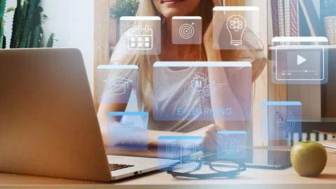 Exploring e learning tools through a laptop and virtual icons in a home Stock Photos