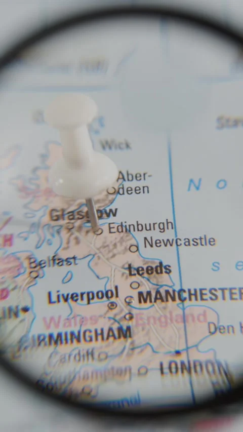 Exploring Edinburgh on a real paper map with a magnifying glass Stock Footage 340078995