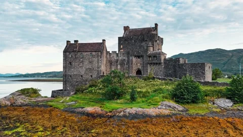 Exploring Eilean Donan Castle from above in the Scottish Highlands Stock Footage 314000985