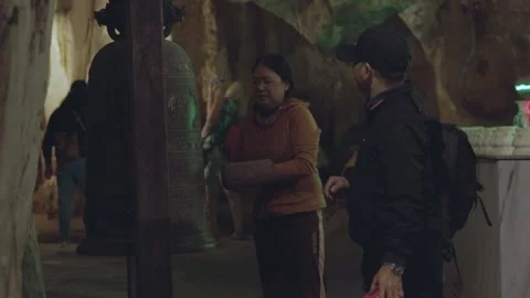 Exploring the enchanting cave with local guides and tourist visitors Stock Footage 312242804