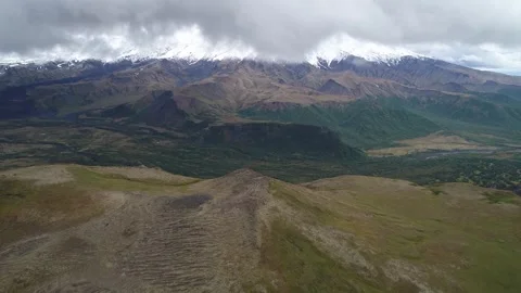 Exploring an expansive valley with a snow-capped mountain Stock Footage 316802079