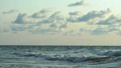 Exploring the gentle waves and expansive skies over the Baltic Sea at sunset Video stock 311865995