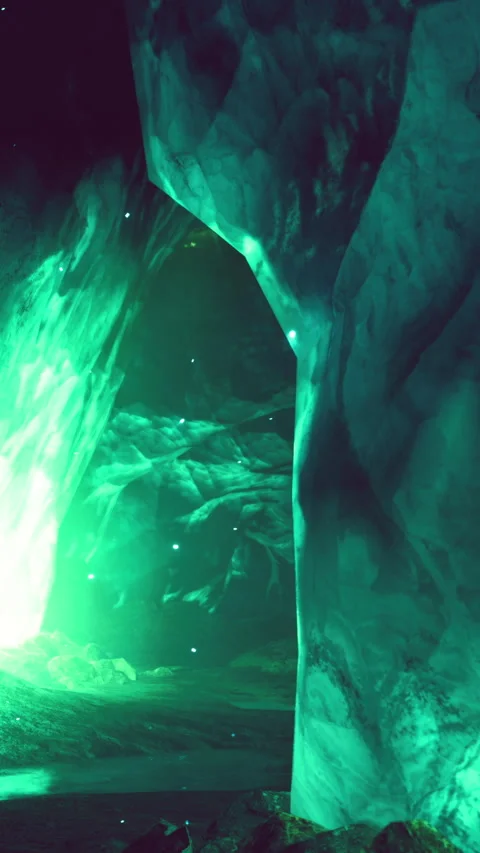 Exploring a glowing ice cave with green light in the rocky landscape Stock Footage 338001670