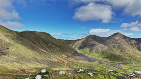 Exploring the green hills of Lanzarote, Spain under blue sky Stock Footage 331801173