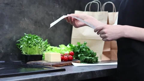 Exploring healthy cooking options with fresh ingredients and a recipe Vídeo Stock 296315952