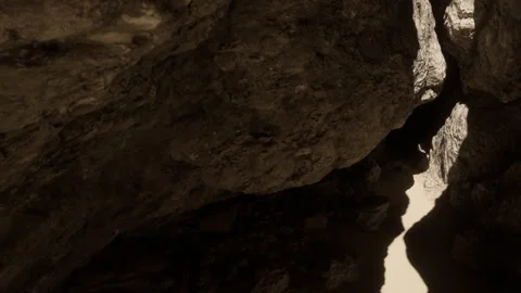 Exploring the Hidden Cave of Shadows and Light at Midday Stock Footage 344544333