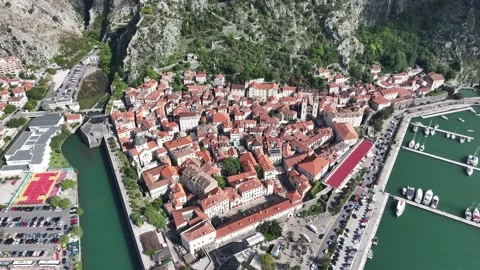 Exploring the historic charm of Kotor Old Town at sunrise with stunning aerial Stock Footage 287781201