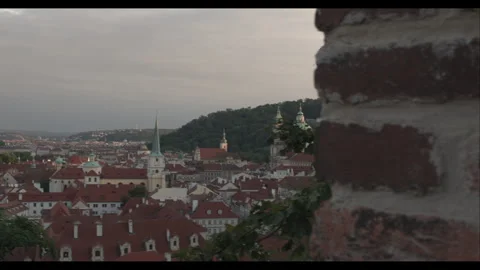 Exploring a historic stone wall while overlooking the city skyline at dusk in a Stock-Footage 283795438