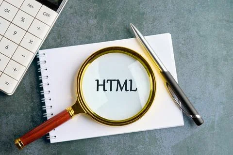 Exploring HTML Concepts With a Magnifying Glass on a Notebook Alongside a C.. Stock Photos