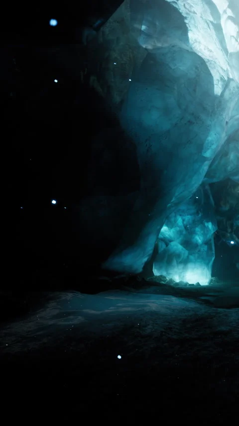 Exploring ice cave with blue light and natural rock formations at night Stock Footage 337975134
