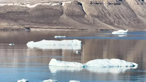 Exploring icebergs and water in a beautiful region with waves and clear skies Video stock 344741522