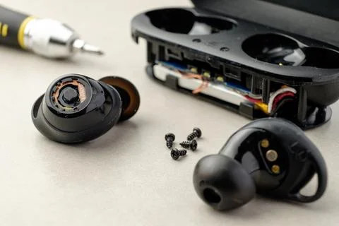 Exploring the inner workings of wireless earbuds in a creative workshop setting Stock Photos