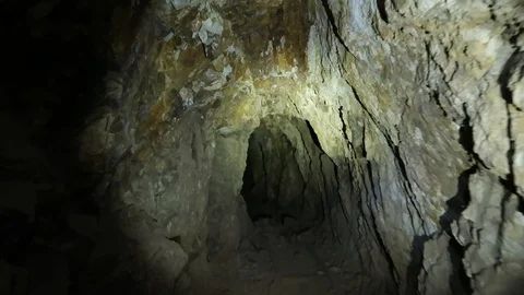 Exploring inside and Abandoned Gold Mine by Flashlight Stock-Footage 96231904