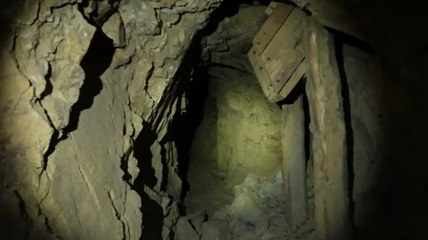 Exploring inside and Abandoned Gold Mine by Flashlight Video stock 96231978