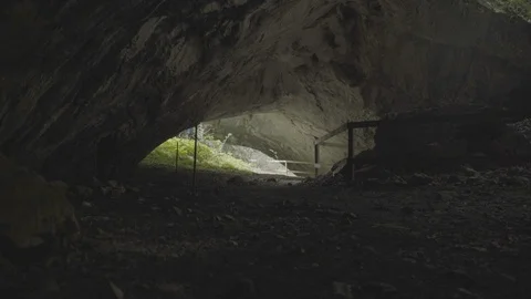 Exploring inside a cave Stockbeeldmateriaal 99653008