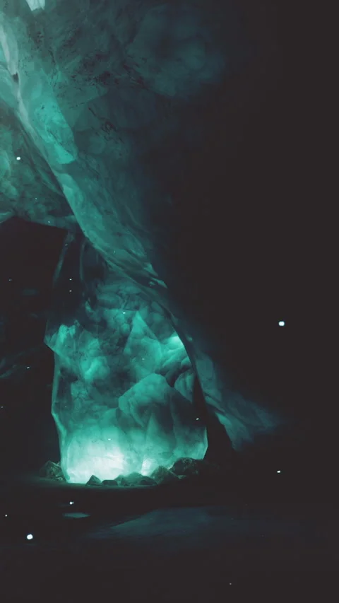 Exploring the interior of a cave with glowing green light at night Stock Footage 337968938