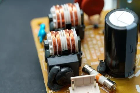 Exploring the internal landscape of modern electronics reveals coils, capac.. Stock Photos