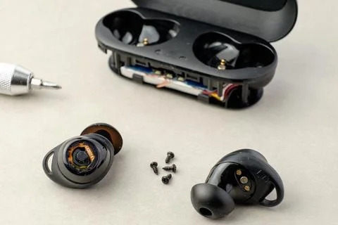 Exploring the internals of wireless earbuds during repair session Stock Photos