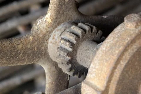Exploring the intricate details of a rusty gear mechanism in motion Stock Photos