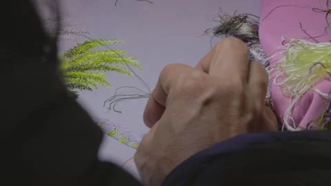 Exploring intricate embroidery techniques in a creative workspace Video stock 312242712