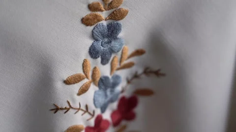 Exploring intricate hand-embroidered textile designs with floral patterns Stock Footage 291154456