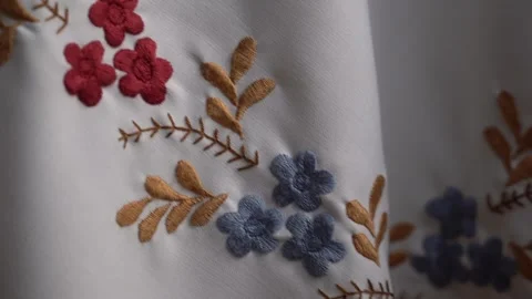 Exploring intricate hand-embroidered textile designs with floral patterns Stock Footage 306223522