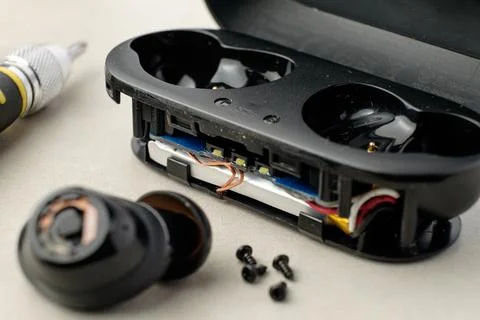 Exploring the intricate inner workings of wireless earbuds on a clean surface Stock Photos