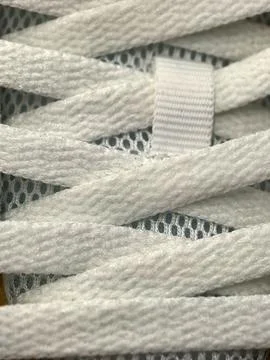 Exploring the intricate patterns of white shoelaces on a textured surface Stock Photos