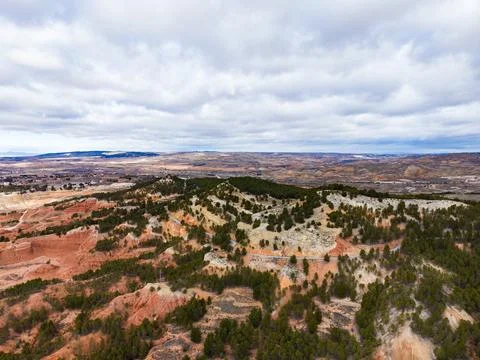 Exploring the landscape of Teruel with hills, trees, and clouds under a sky.. Stock Photos