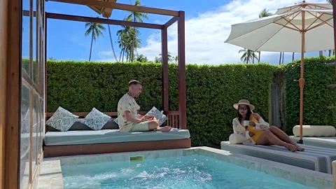 Exploring life as a digital nomad in Thailand while working by the pool 스톡 동영상 296305435