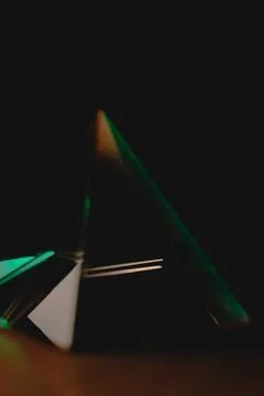 Exploring light reflections in a shimmering glass prismatic pyramid Photos