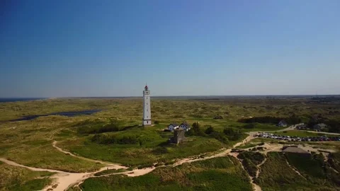 Exploring a lighthouse and its surroundings near the coast with wide open v.. Stock Footage 339940236