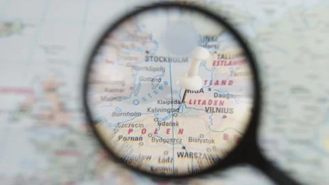 Exploring the location of Klaipeda on a paper map of Europe Stock Footage 340079012