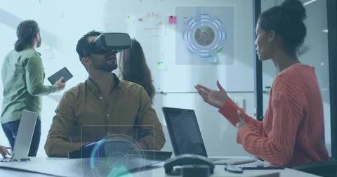 Exploring man wearing VR headset, button shirt navigating AR UI at meeting ta Stock Photos