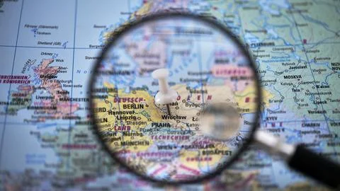 Exploring a map of central Europe with a magnifying glass Stock Photos
